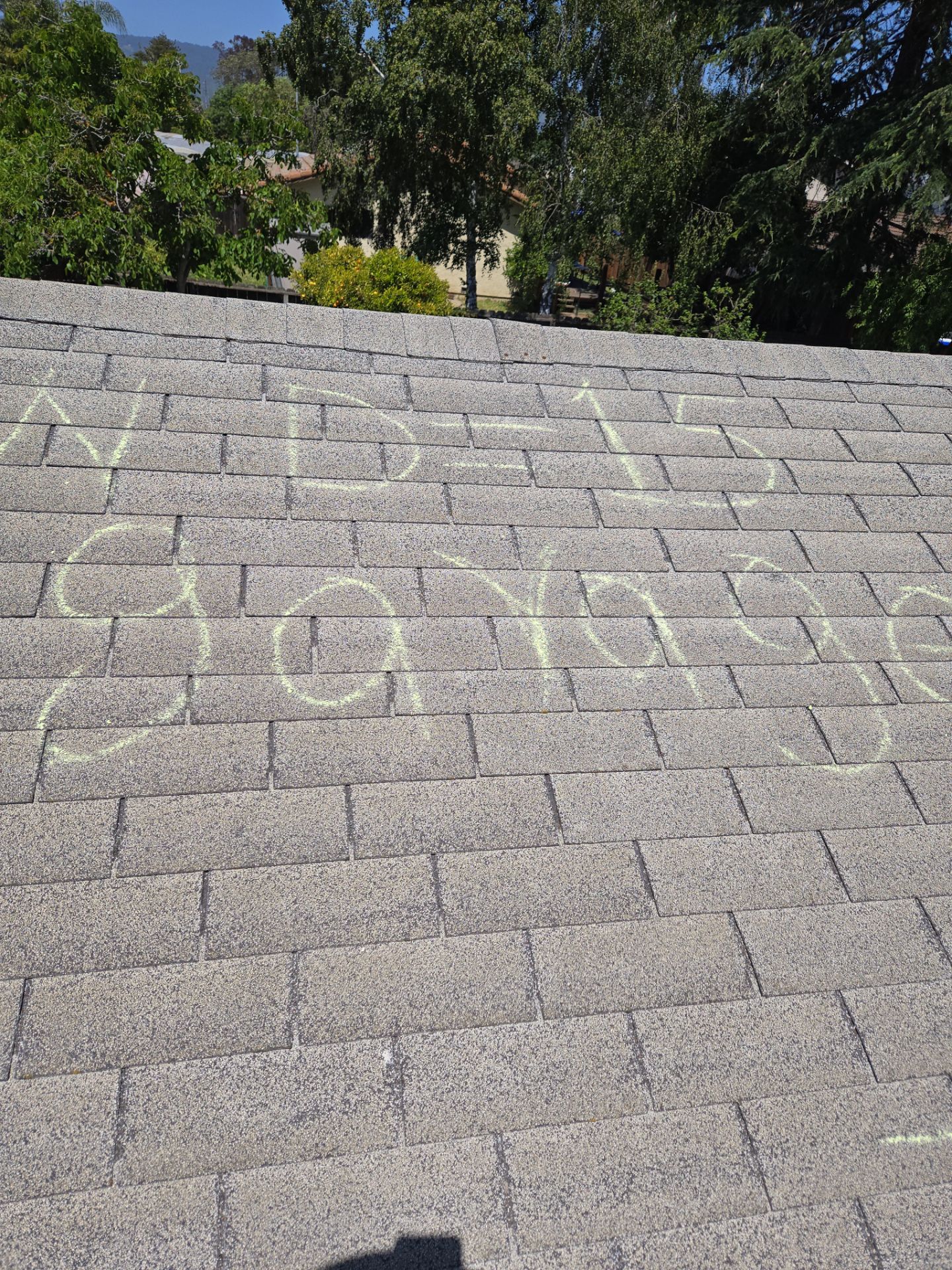Chalk-marked wind damage labeled WD-13 Garage documented during a roof inspection