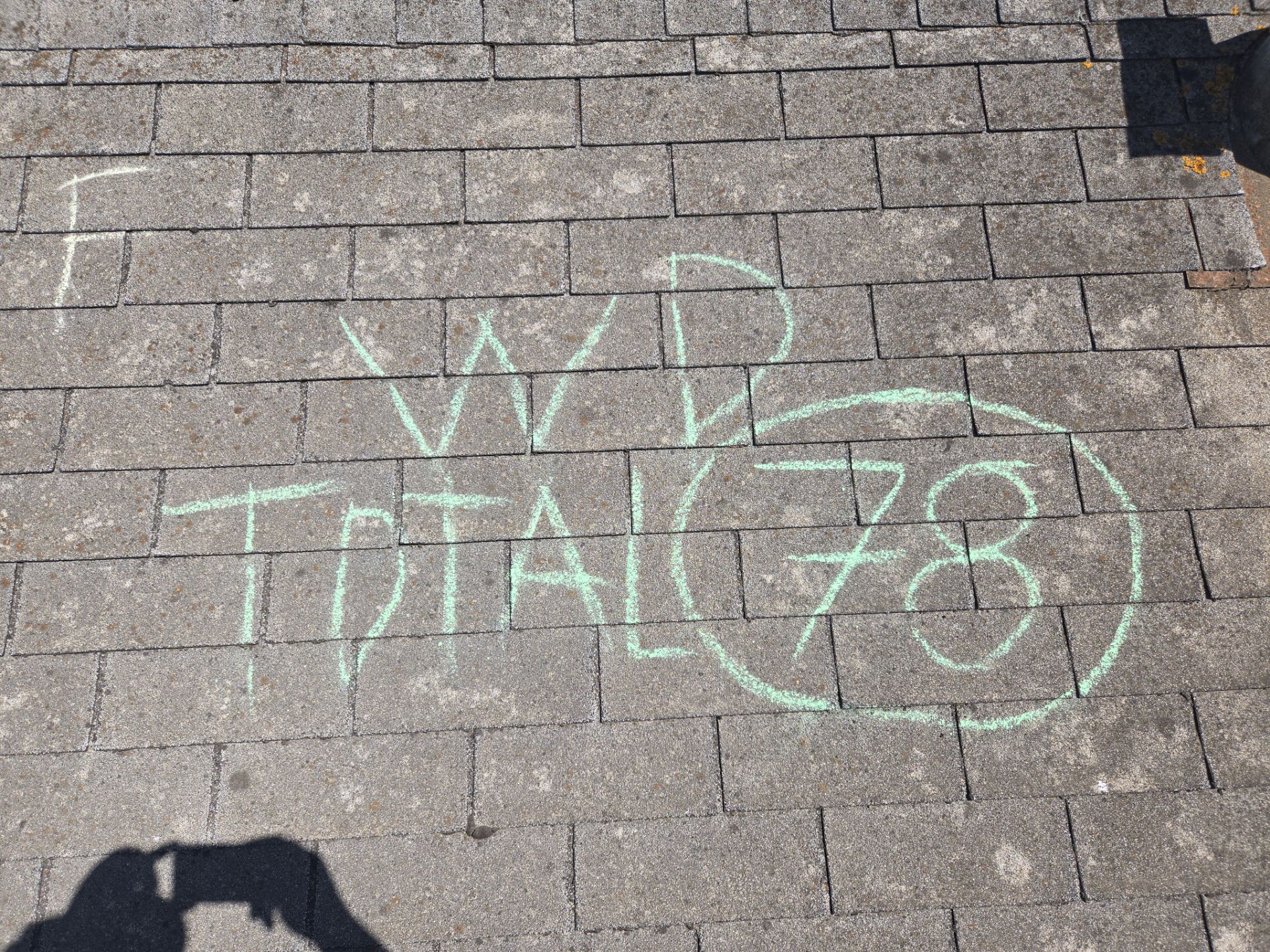 Chalk-marked damage tally labeled WD Total 78 documented during a storm damage inspection