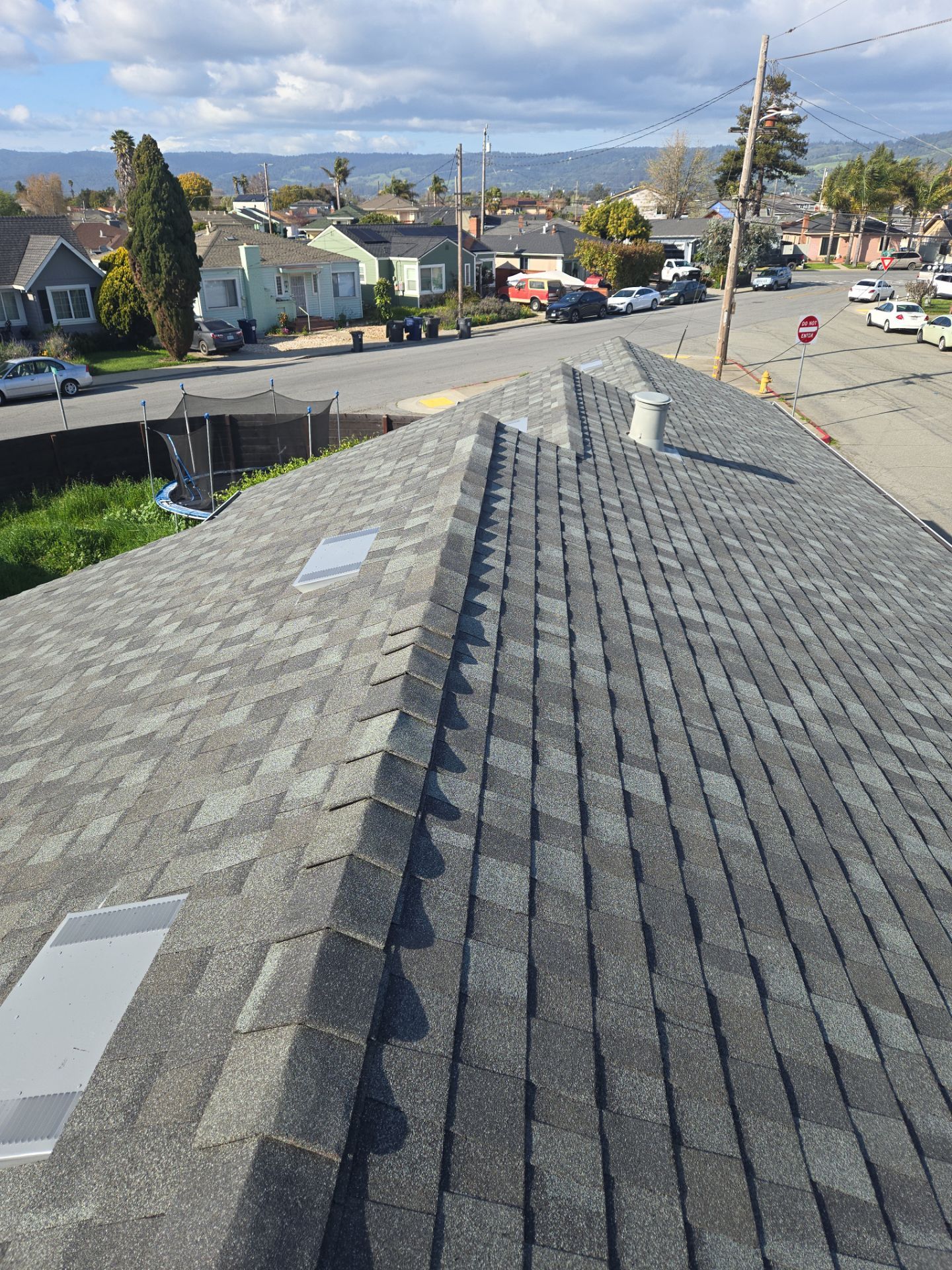 Roof ridge line inspected for storm damage during a claim assessment