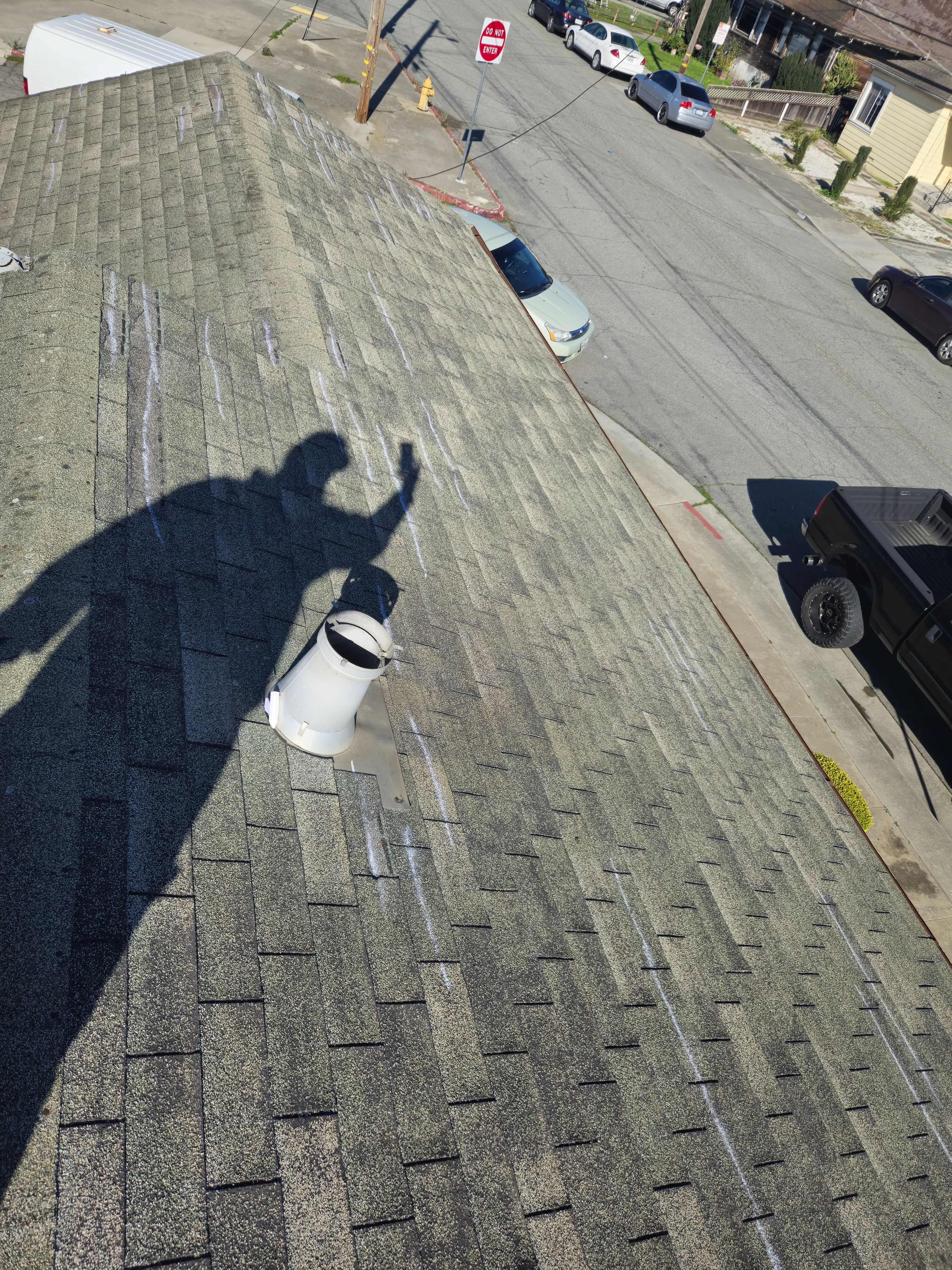 Blue Sky Roofing Group inspector marking wind damage on a roof during a storm damage inspection